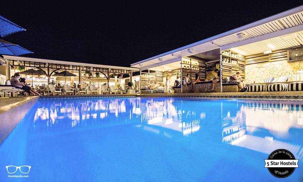 The blue-color swimming pool by night at Rambutan Townsville